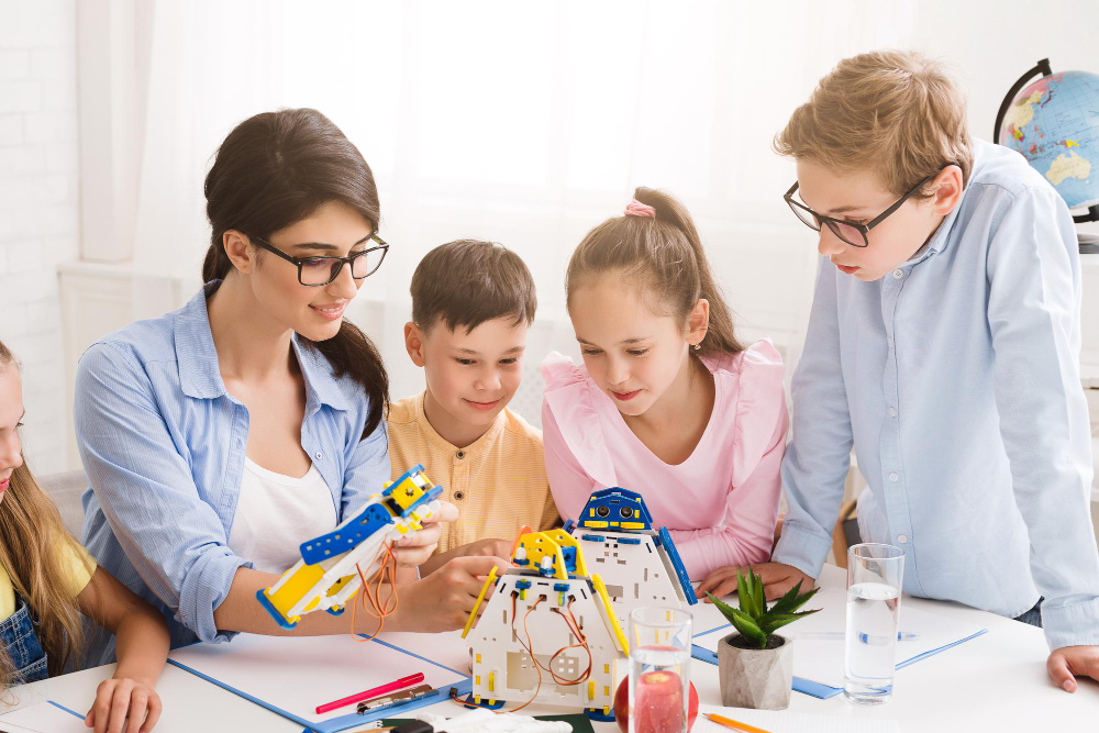 Students and teacher building a robotics project during a hands-on STEM program in Brooklyn NY