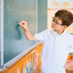 Focused student solving math equations on a chalkboard demonstrating how STEM teaches kids to solve problems through applied thinking