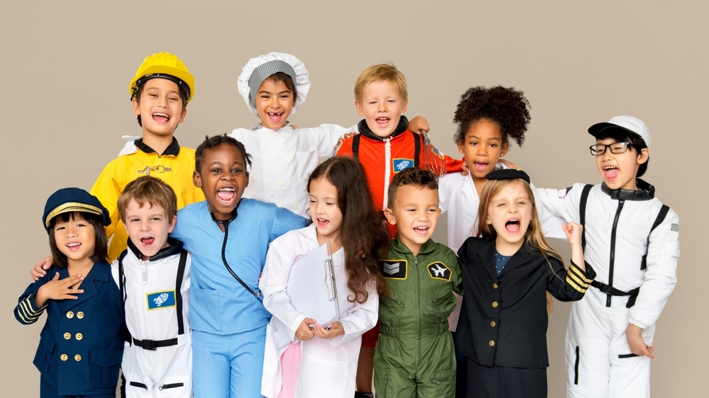 Diverse group of children dressed in career costumes representing the wide range of STEM careers for kids available in the future
