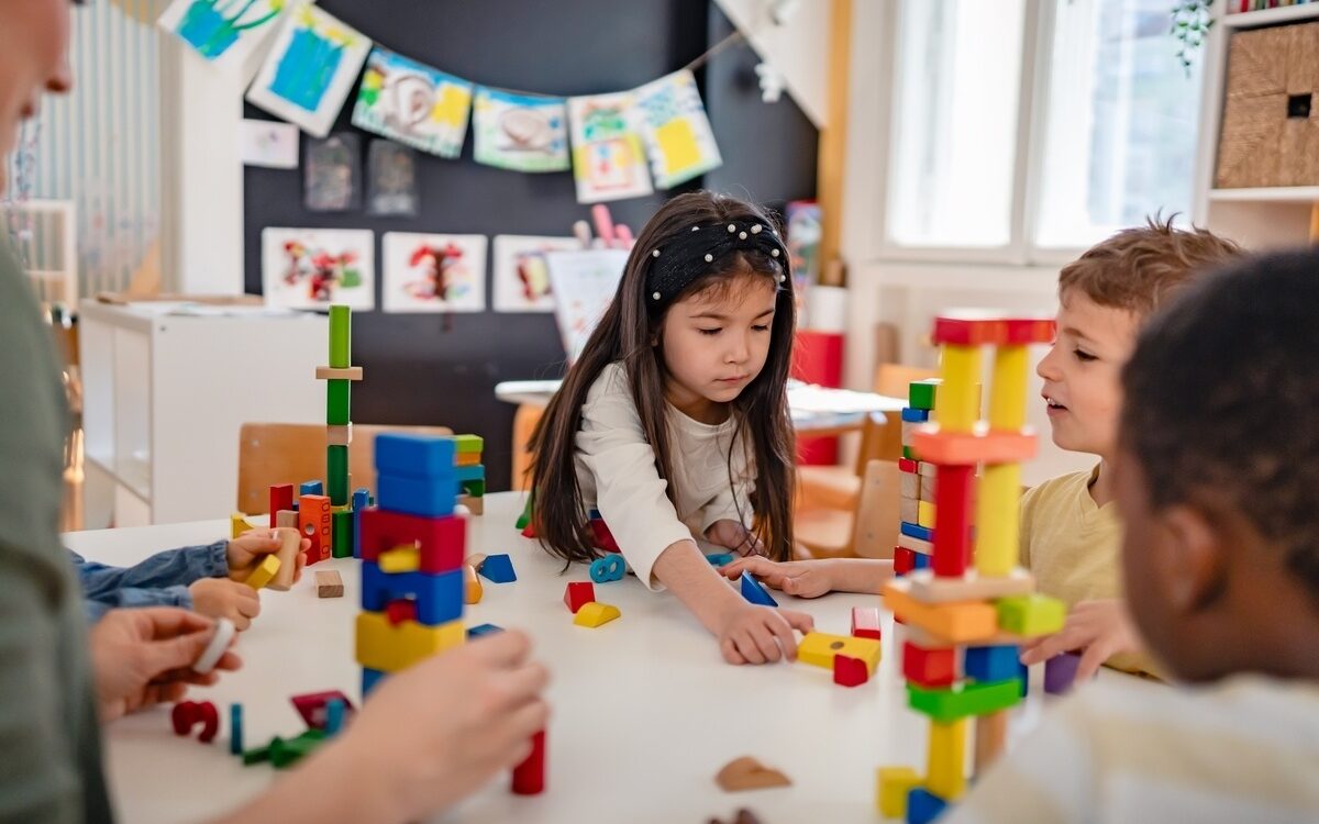 Preschool children building block towers during play-based STEM learning activity
