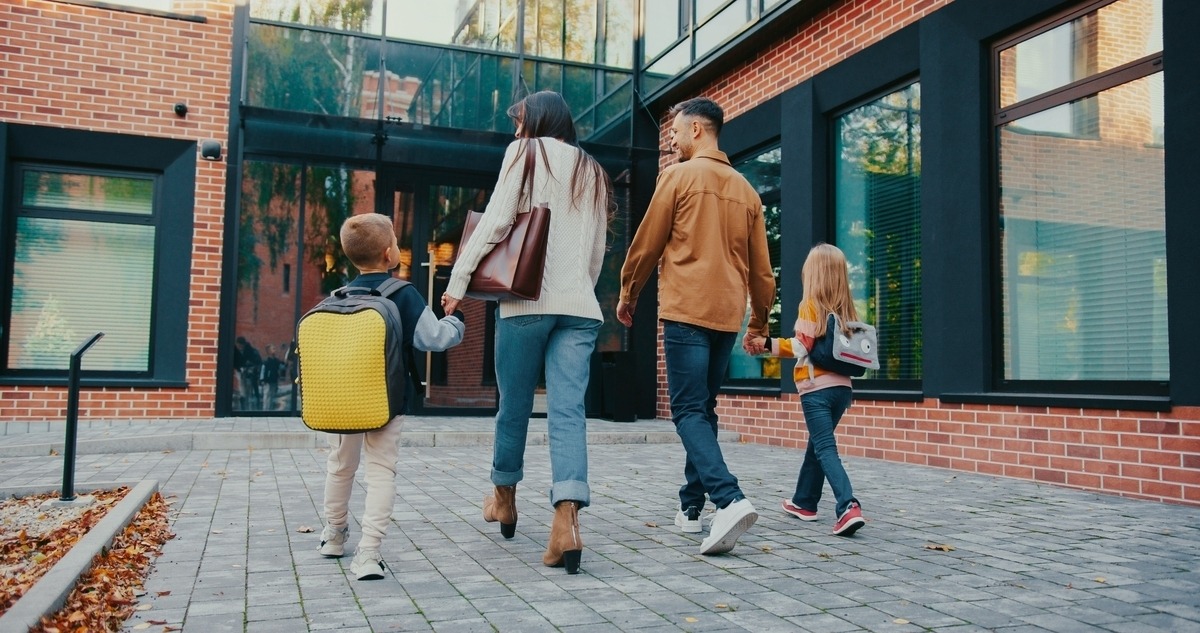 Family walking into a private school building after learning about private school financial aid