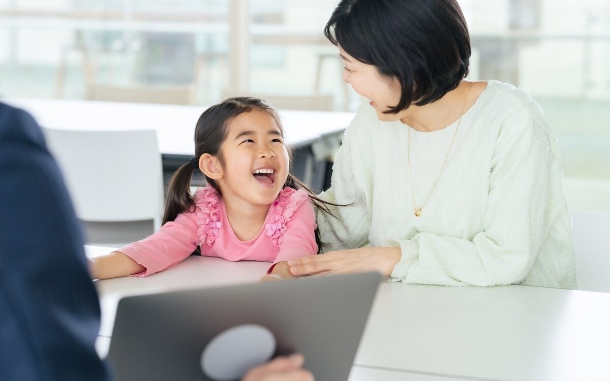 Child laughing with parent during a private school interview conversation