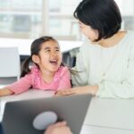 Child laughing with parent during a private school interview conversation