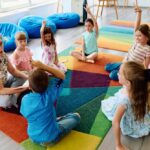 Teacher facilitating an engaged small group discussion with young students illustrating how private school social development happens through daily structured peer interaction
